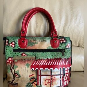 Genuine leather Anushka purse. Sides expand. Leather straps. Rivets on bottom.